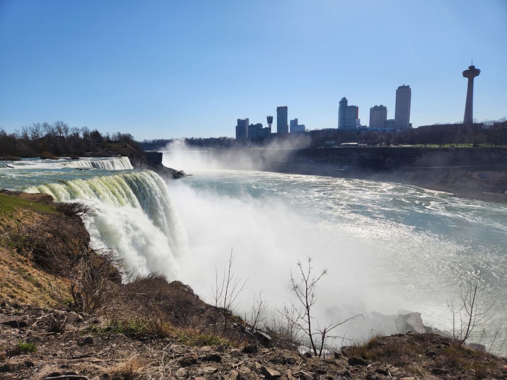 A view of the American side of Niagara Falls to the left, and the tall hotels on the Canadian side of the border to the right. 