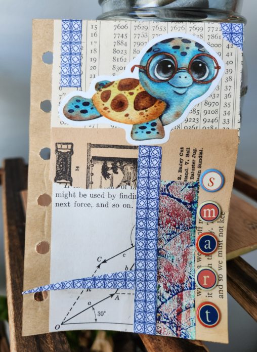 A 3x5 piece of paper with a mixed media collage. Different vintage and colored papers make up the background. A sticker of a sea turtle with glasses is across the top center. The word "smart" runs down the right bottom edge.