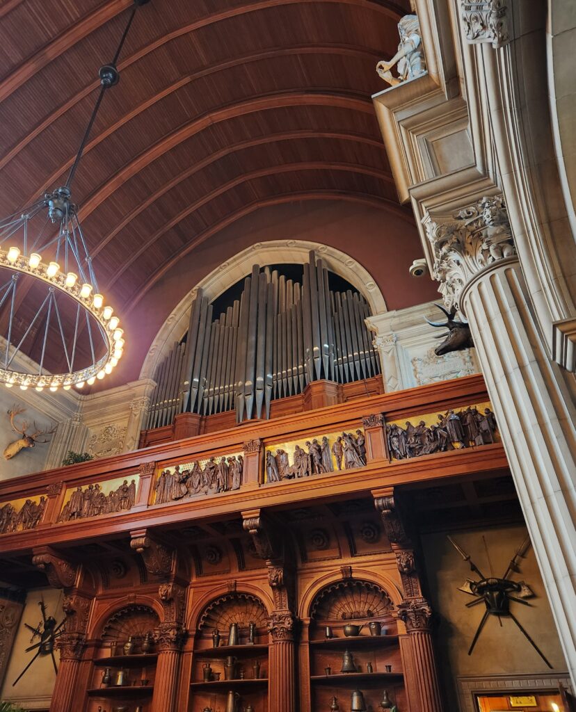 The pipe organ pipes that are in the Banquet Hall of the Biltmore House. They are sitting within the second story balcony. 